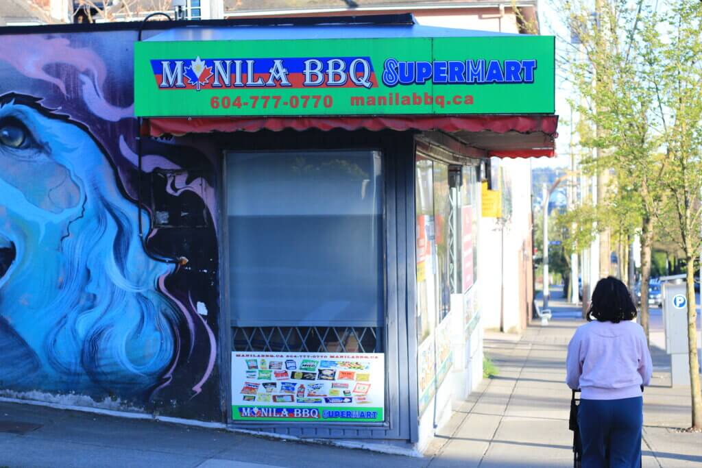 A shopper walks outside of Manila BBQ Supermart. 